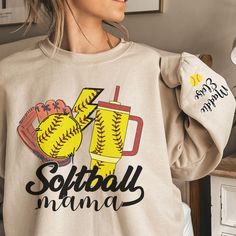 a woman wearing a sweatshirt with softball designs on it