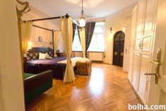 a bedroom with wood floors and white walls