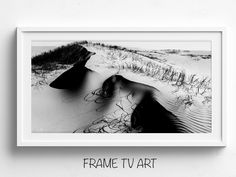 a black and white photo with the words frame tv art in front of an image of sand dunes