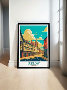 a framed poster is sitting on the floor in front of a white wall and window