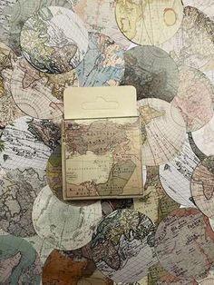 an old world map is laying on top of a tablecloth covered with paper circles