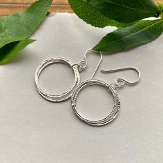 Elegant, Light & Sparkly Double Hoop Earrings -- Beautiful with all of the milestone necklaces. These are perfect for everyday wear.✦ All metal is bright sterling silver.✦ Circles have been given a unique hammered texture, and are organically shaped.✦ Each jump ring has been soldered closed for extra handmade quality.✦ Earrings are 1 5/8 inches long, including the french hook ear wires✦ Largest circles are 7/8" wide. Adjustable Cadmium-free Sterling Silver Hoop Earrings, Sterling Silver Hammered Circle Jewelry, Hammered Sterling Silver Circle Jewelry, Silver Hammered Hoop Earrings For Everyday, Silver Hand Forged Hoop Earrings For Anniversary, Silver Hammered Hoop Earrings For Anniversary, Sterling Silver Hammered Hoop Earrings, Everyday Silver Hammered Hoop Earrings, Small Hoop Hammered Sterling Silver Jewelry