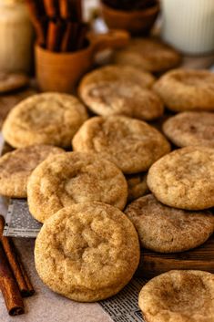 cinnamon sugar cookies on a table with cinnamon sticks