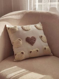 a pillow with hearts on it sitting in a chair