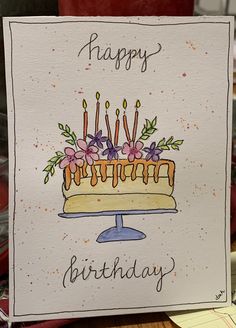 a birthday card with a cake and candles on it