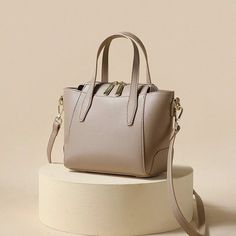 Indulge in sophistication with our Light-Toned Leather Tote Bag. Crafted for the modern woman, this elegant handbag adds a touch of refined style to any occasion. The light colors elevate the chic and timeless appeal, making it the perfect accessory for your graceful ensemble. Lining Material: Polyester Main Material: Split Leather Interior Slot Pocket Handbag Size (inches): 7.87x6.7x4.3 inches Handbag Size (cm): 20x17x11 cm Trendy Formal Satchel, Chic Large Capacity Satchel, Chic Beige Evening Bag With Large Capacity, Chic Satchel With Large Capacity, Modern Solid Color Evening Bags, Modern Evening Bags, Modern Evening Bags In Solid Color, Solid Color Box Bag For Evening, Elegant Large Capacity Solid Shoulder Bag