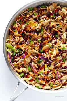 a pan filled with chicken and veggies on top of a white countertop