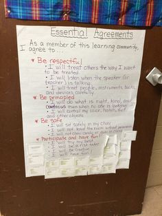 a bulletin board with writing on it in front of a door that says essential agreements