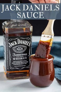 jack daniels sauce in a jar with a wooden spoon