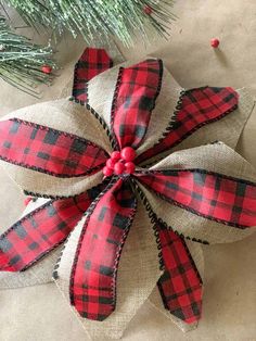 a red and black plaid christmas ornament hanging from a tree