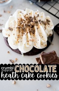 chocolate cookies with white frosting and crumbs on top