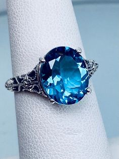 Natural London Blue Topaz Ring/ Solid Sterling Silver/ 3ct Oval Cut/ Medieval Floral Filigree [Made To Order] Design#173 Oval Topaz Ring With Aquamarine And Gemstone Accents, Victorian Oval Topaz Rings, Victorian Blue Oval Topaz Ring, Antique Oval Topaz Ring, Oval Turquoise Topaz Ring, Turquoise Oval Topaz Ring, Heirloom Blue Topaz Oval Ring, Heirloom Oval Blue Topaz Ring, Ornate Oval Topaz Ring With Intricate Design