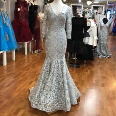 a mannequin in a store with dresses on display