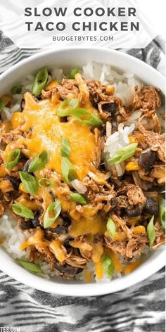 slow cooker taco chicken bowls in a white bowl with rice and green onions