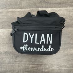 a black bag with white lettering that says dylan flowerdale on the front