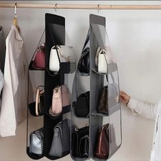 a woman standing in front of a rack with shoes and handbags on hangers