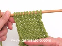 someone is crocheting the stitchs together with a knitting needle and wooden skewer