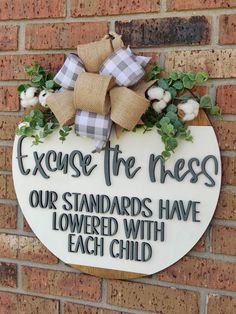 a sign on the side of a brick wall that says, exercise the rest our standards have lowered with each child