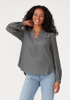 A classic lightweight blouse with long sleeves and a smocked waist accent at the back. Relaxed fit Long sleeve Single-button wrist closure V-neckline Smocked waist detail at the back Classic blouse A soft draped popover blouse that transitions from the office to happy hour with ease. Featuring a unique cinched smocked detail at the back waist and a flattering v-neckline. Model is 5'8, wearing a size S.Style: I-15204W-SNI Flowy V-neck Top For Work, Stretch Rayon V-neck Blouse, Fall V-neck Peasant Top With Smocked Cuffs, V-neck Blouson Sleeve Work Tops, Fall V-neck Top With Elastic Sleeves, Versatile Long Sleeve V-neck Top For Work, Stretch Split Neck Blouse, Versatile V-neck Viscose Blouse, Elegant V-neck Peasant Top For Fall