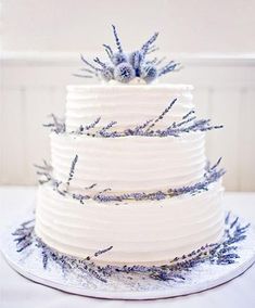 a three tiered white cake with lavender sprinkles