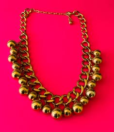 This vintage chunky gold chain and dangling gold bead necklace is 19 inches long and 1 1/8 inch tall. This is sturdy with an adjustable lobster claw and chain clasp. The necklace is in beautiful vintage condition. It is not light weight. I specialize in finding fun wearable costume jewelry. Please browse my shop for more options. I box jewelry sales ready to be given as gifts. I often combine multiple item purchases to save on shipping. Please contact me if you wish to combine 3 or more items. Gold Ball Chain Necklace For Party, Gold-tone Beaded Chain Metal Necklace, Gold Metal Ball Chain Necklace, Gold Chain Necklace With Dangling Beads, I Box, Chunky Gold Chain, Wire Cuff, Choker Collar Necklace, Bead Choker