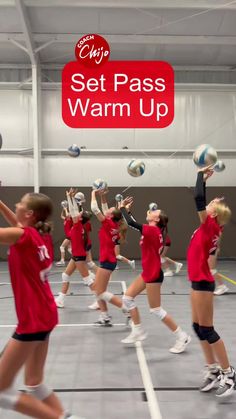 a group of girls in red uniforms playing volleyball on an indoor court with the words set pass warm up above them