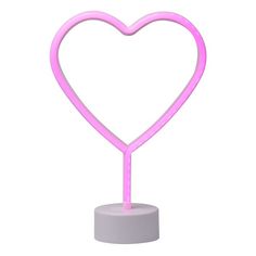 a pink heart shaped light on top of a white stand