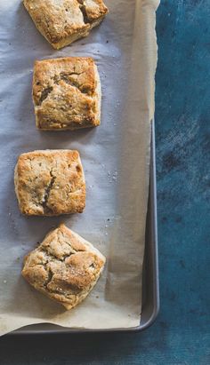 four scones on a baking sheet ready to be baked in the oven and eaten