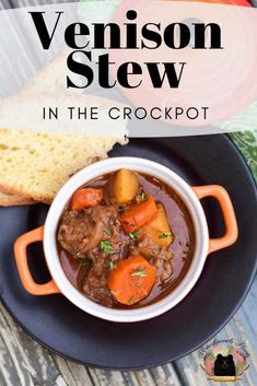 a bowl of stew with carrots and bread on the side