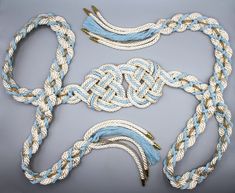 two pieces of blue and white rope with gold clasps