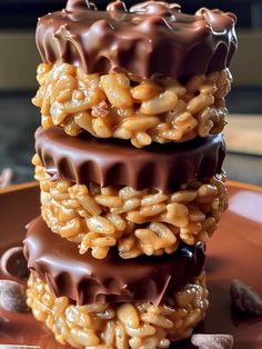 chocolate covered cookies stacked on top of each other in the shape of hearts and nuts