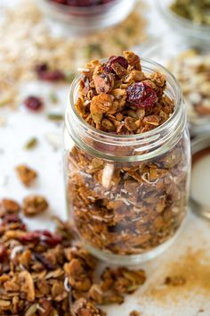 an apple pie granola in a glass jar on top of a table with the title above it