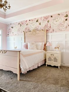 a bedroom decorated in pink and white with floral wallpaper on the walls, dressers and bed