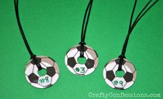 three necklaces with soccer balls and numbers on them