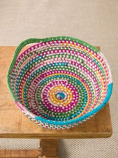 a multicolored bowl sitting on top of a wooden table