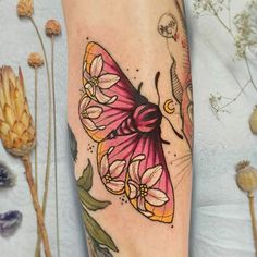 a colorful butterfly tattoo on the leg