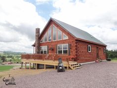 a log cabin with a porch and stairs