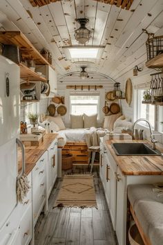 the interior of a tiny home with wood flooring and white walls, windows, and cabinets