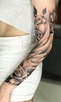 a woman's arm with flowers and leaves tattooed on the left side of her body