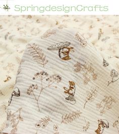 a close up of a blanket with animals on it and flowers in the background that says springdesigncrafts