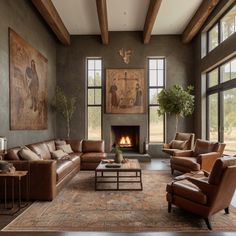 a living room filled with lots of furniture and a fire place in the middle of it