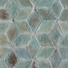 a close up view of a blue and green mosaic tile wallpaper with hexagonal shapes