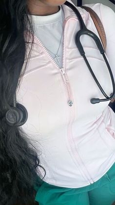 a woman with long hair wearing a stethoscope