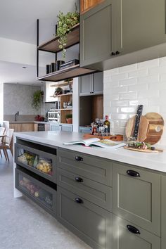 a kitchen with gray cabinets and white counter tops