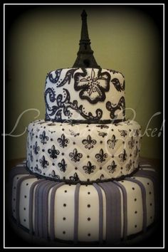 three tiered cake decorated with black and white designs