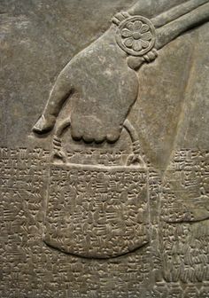 an ancient stone with writing on it and a bird in the middle, as well as another type of text