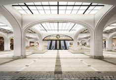 an empty train station with people walking through it