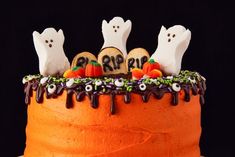 a halloween cake decorated with ghost and pumpkins