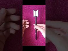 two pictures of hands holding an object in the shape of a book and pointing it at something