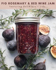 figs and rosemary sprigs surrounding a jar of jam